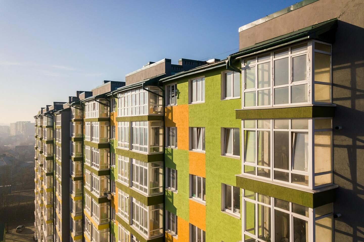 aerial-view-of-a-tall-residential-apartment-building-with-many-windows-and-balconies-474NDHS.jpg